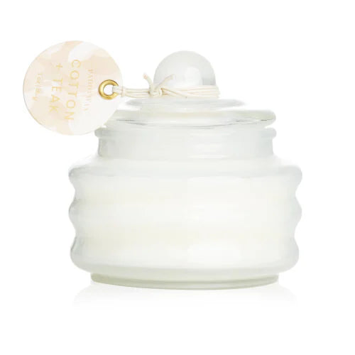 White glass jar candle with metal clasp and round scent tag