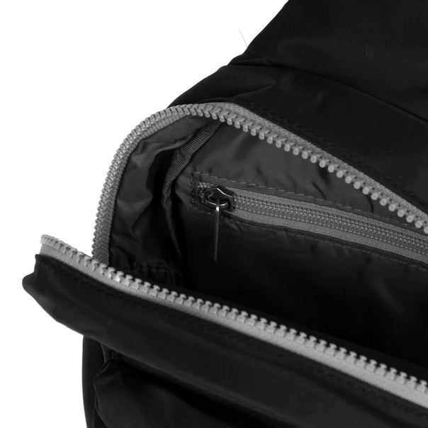 Black sling bag interior view with zippered compartment and stitched zipper track