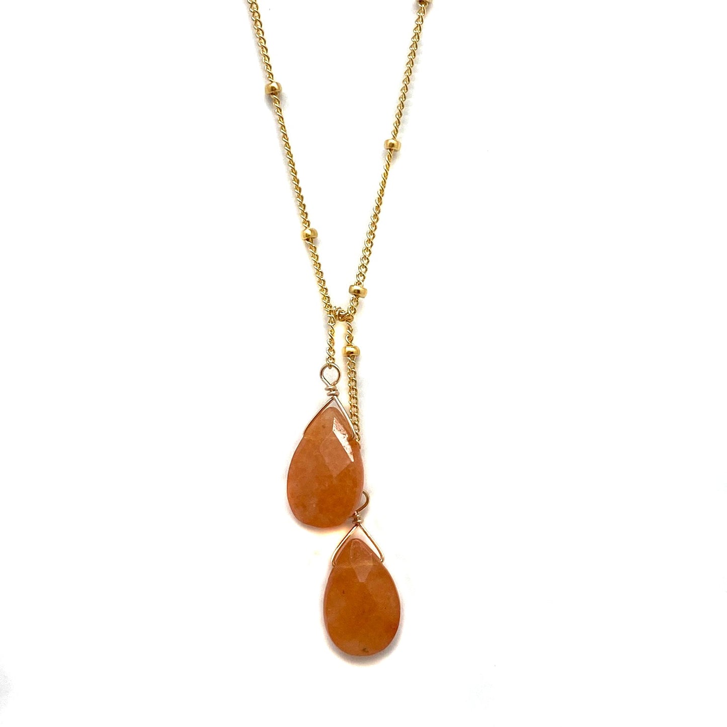 Gold-filled lariat necklace with two warm orange teardrop stone drops