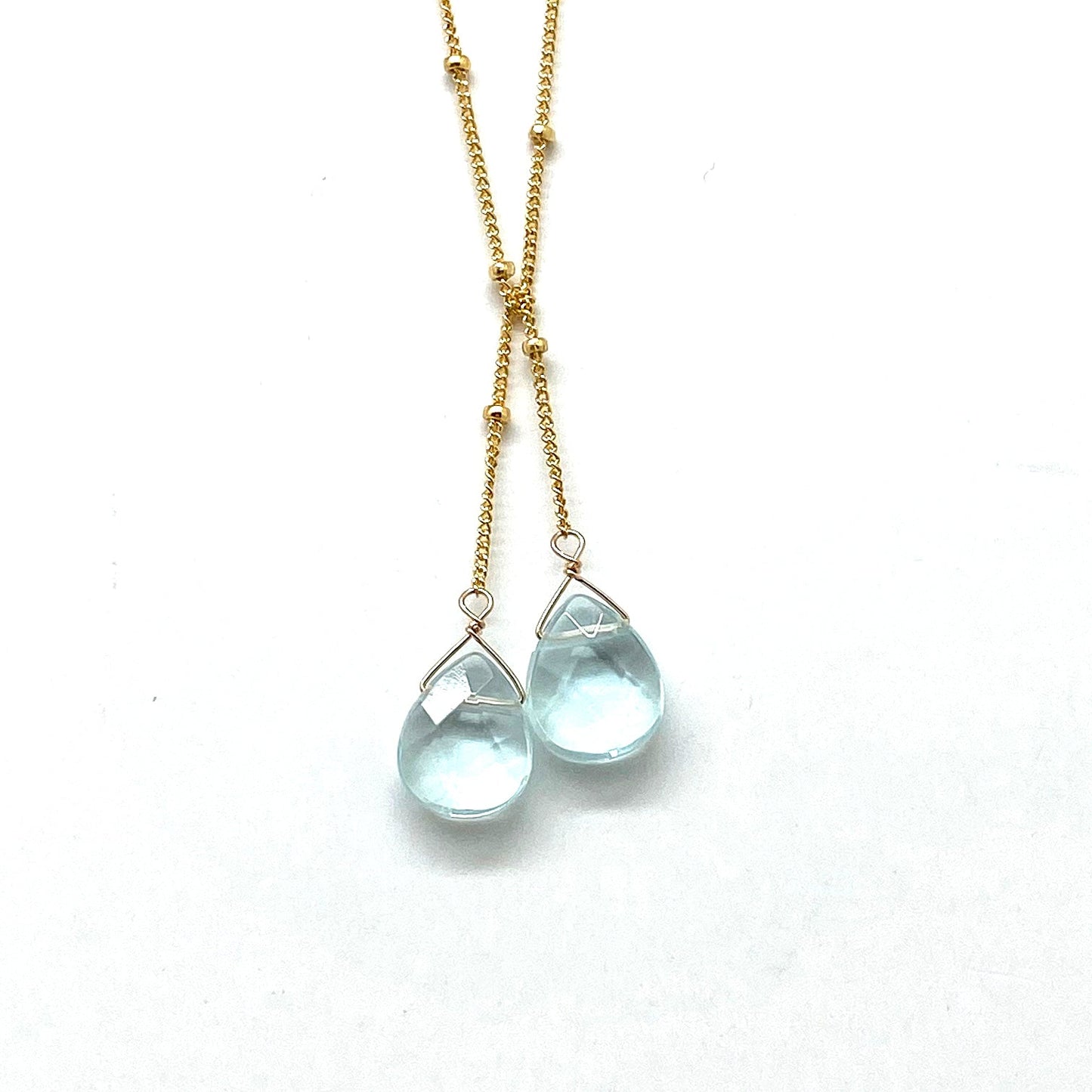 Gold-filled lariat necklace with two sky blue teardrop stone drops