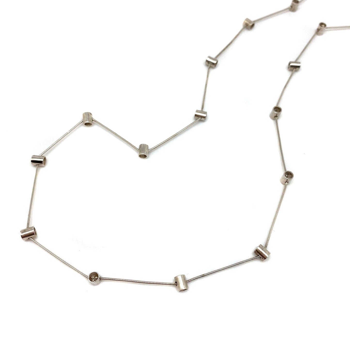 Sterling silver pivot necklace with bar links and small round accents, open chain
