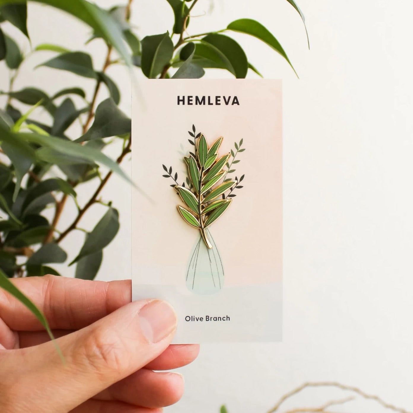 Olive branch enamel pin, gold-tone stem with green and red leaves on card
