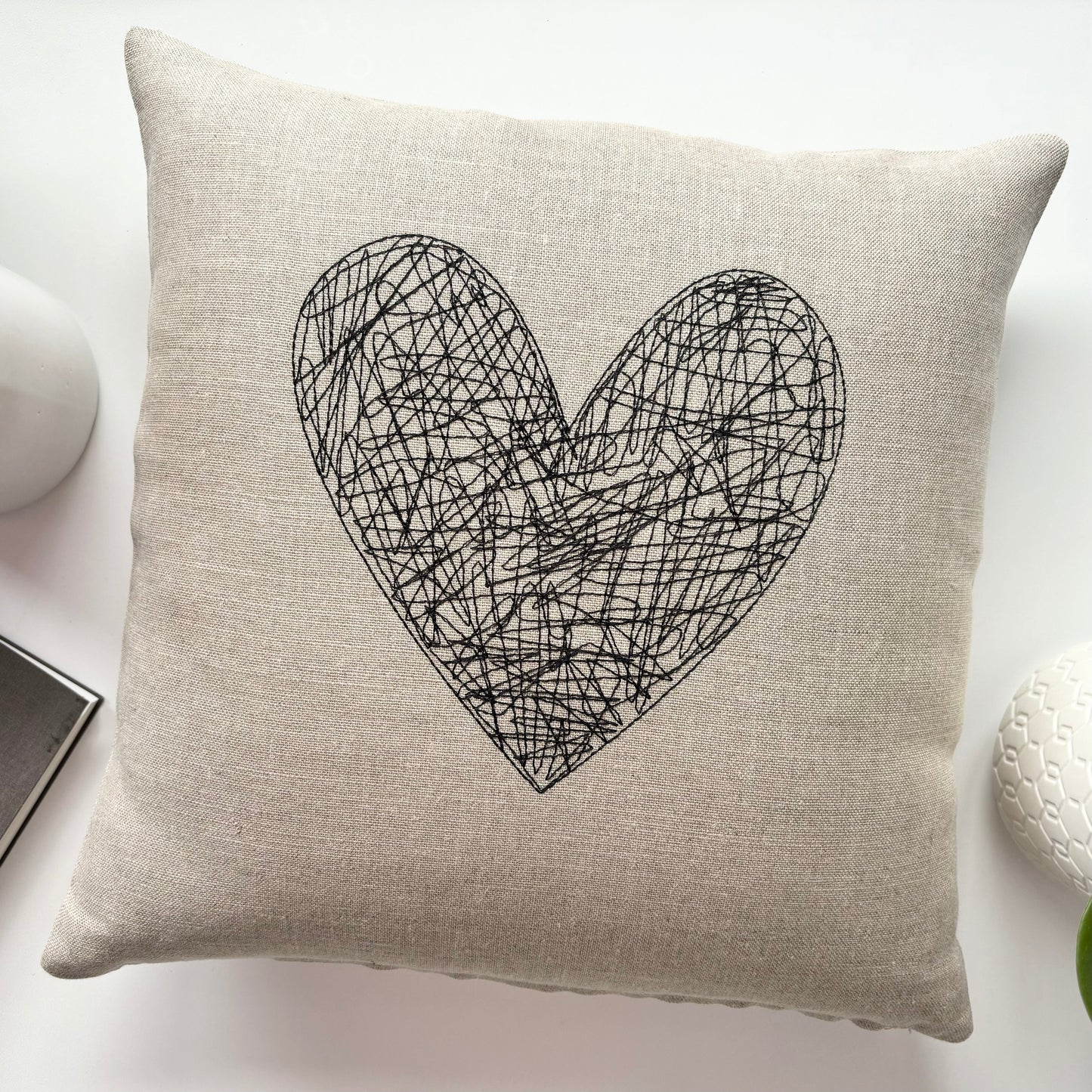 Beige linen throw pillow with black scribble heart front, 14 in size