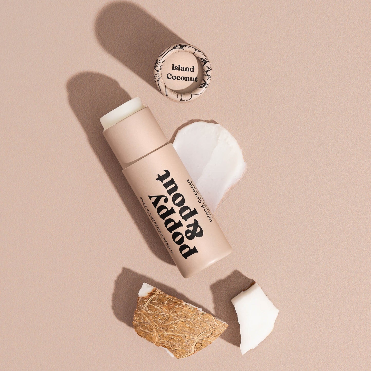 Island Coconut lip balm tube with cap open and white balm residue