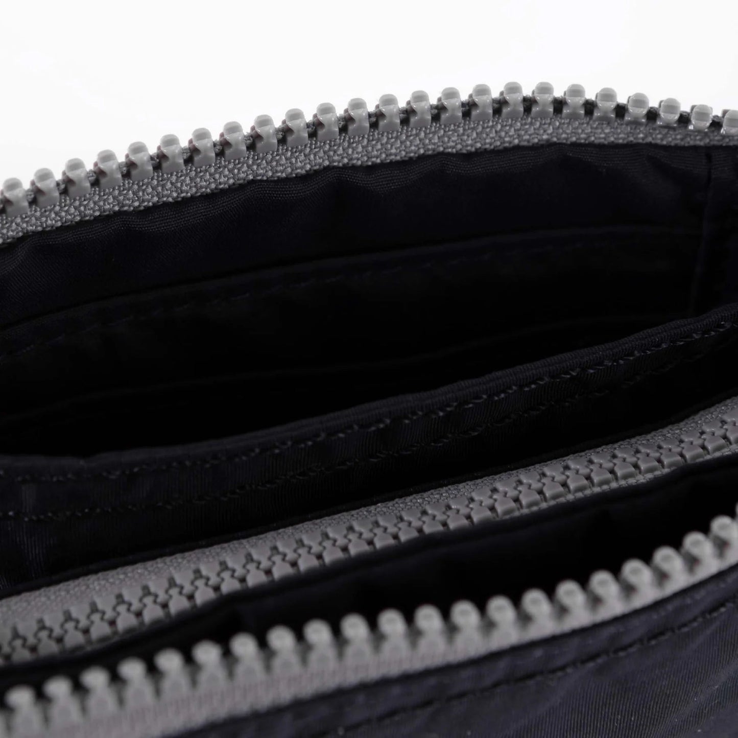 Medium recycled canvas zipper pouch interior, black lining and zipper teeth close-up