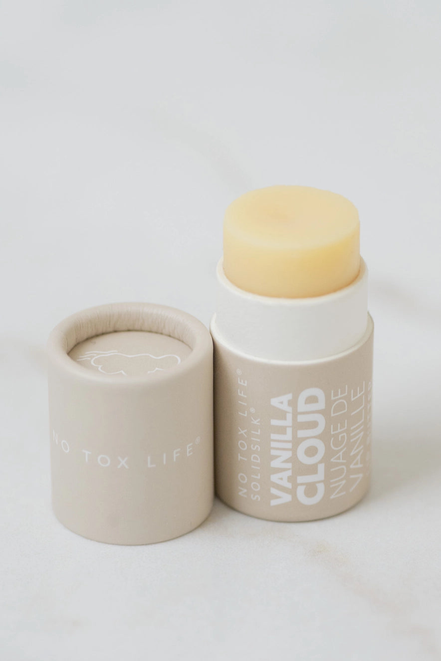 Vanilla lip butter containers with open balm top and pale yellow center