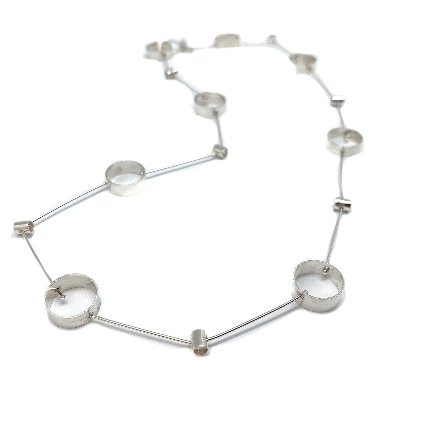 Silver-tone pivot necklace with round disc links and tube connectors