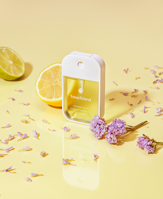 Hydrating hand sanitizer spray bottle with pale yellow label panel and dispenser head